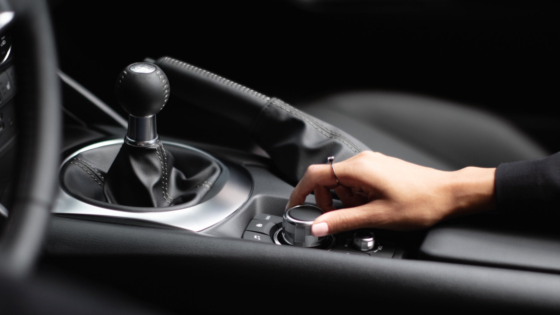 A driver in a Mazda MX-5 Miata