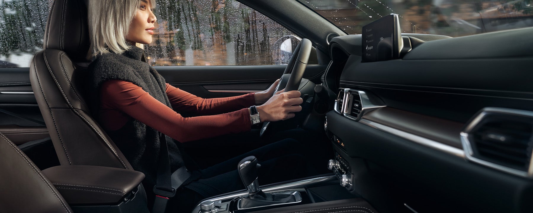 A woman driving a Mazda CX-5