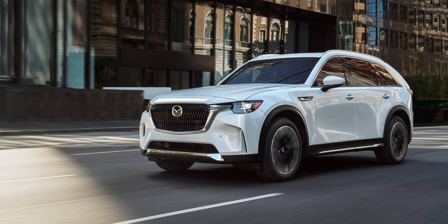 Mazda CX-90 PHEV driving through the city