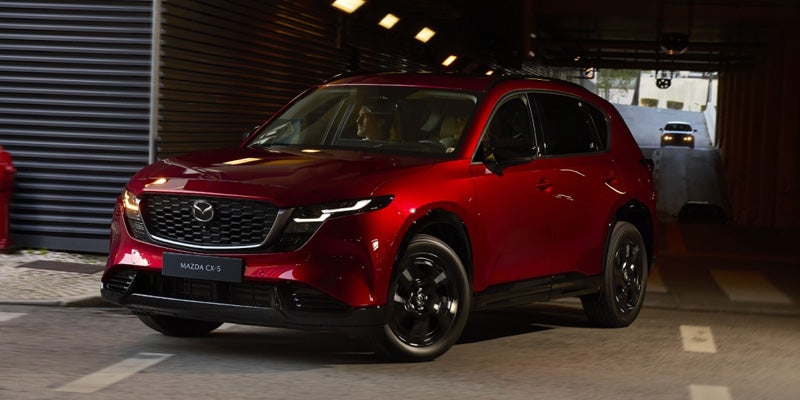 A red Mazda CX-5 SUV driving through a tunnel.